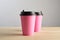 Paper coffee disposable cup for take away or to go, wooden table, space for design mock-up