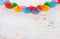 Paper colorful chain garland over white wooden background. Traditional jewish sukkot holiday decoration