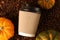 Paper craft cup within coffee beans and pumpkins.Spicy latte or coffee concept.Horizontal banner