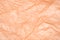 Paper crumpled texture soft peach fuzz color. Trending color of the year 2024.