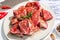 Paper culinary recipe for preparation pork. Raw ingredients includes pork loin pieces, spices, herbs