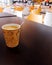 Paper cup of coffee on cafeteria table top