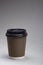 Paper cup with coffee cappuccino on grey background Close up