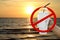 Paper cup white and straws in hand over sea beach sunset evening and stop red sign forbidden symbol, campaign no use and ban