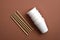 Paper cups and bamboo drink straws on brown background. Zero waste concept. Flat lay, top view. Plastic free sustainable lifestyle