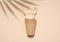 Paper cups and disposable wooden forks on a beige background, top view