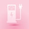 Paper cut Electric car charging station icon isolated on pink background. Eco electric fuel pump sign. Paper art style