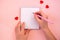 Paper cut hearts, notepad on pastel pink background. Composition for Valentine`s Day, postcard. Flat lay, top view, copy space