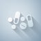 Paper cut Medicine pill or tablet icon isolated on grey background. Capsule pill and drug sign. Pharmacy design. Paper