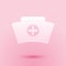 Paper cut Nurse hat with cross icon isolated on pink background. Medical nurse cap sign. Paper art style. Vector