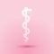Paper cut Rod of asclepius snake coiled up silhouette icon isolated on pink background. Emblem for drugstore or medicine