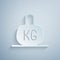 Paper cut Weight icon isolated on grey background. Kilogram weight block for weight lifting and scale. Mass symbol