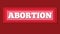 Paper cut word abortion in red background