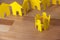 Paper cutout people standing in a circle against paper houses