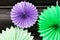 Paper decor for the holiday, birthday, new year, wedding in the form of a round fan in purple and green.