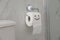 Paper with drawn funny face near toilet tank