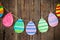 Paper Easter painted eggs painted hang on clothespins on backgr