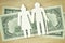 Paper elderly couple cut-out on dollar banknotes - Pension concept