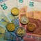 paper euro banknotes and coins. Coins one, two euros. Coins twenty and five euro cents.