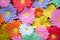 Paper flower. Glade of multi-colored flowers. Red curtain background . Valentine`s Day. Flowers of paper craft colorful backgroun
