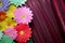 Paper flower. Glade of multi-colored flowers. Red curtain background . Valentine`s Day. Flowers of paper craft colorful backgroun