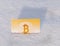 Paper gold money bitcoin in the snow in winter. Frozen account.