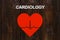 Paper heart with echocardiogram with text CARDIOLOGY