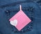 Paper heart with inscription I love you and pink photo frame. Romantic love theme on jeans background