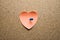 Paper heart with a knob on a chipboard plate