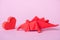 Paper heart near origami dinosaur on