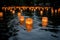 paper lanterns floating in water for a memorial