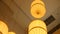 Paper lanterns hanging from the ceiling. Chinese paper lantern hanging from a ceiling. Yellow Chinese paper lantern hang