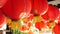 Paper lanterns on shabby building. Red paper lanterns hanging on ceiling of weathered concrete temple building on sunny