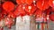Paper lanterns on shabby building. Red paper lanterns hanging on ceiling of weathered concrete temple building on sunny