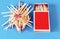 Paper matchbox with a bunch of matches on a blue background