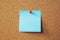 Paper note reminder sticky notes pin paper blue  on cork bulletin board.