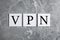 Paper notes with acronym VPN on light grey marble table, flat lay