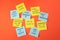 Paper notes with life-affirming phrases on orange background