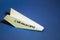 Paper plane lay on classic blue background