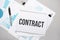 Paper plate with text contract. Diagram, notepad and blue background