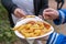 Paper plate with traditional German currywurst and french fries