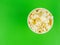 Paper popcorn Cup on a green background. Place for your text.