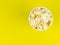 Paper popcorn Cup on a yellow background. Place for your text.