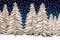 paper quilling winter landscape of white christmas trees and snow