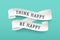 Paper ribbon with text Think Happy Be Happy