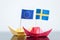 Paper ship with swedish and european flag