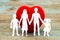 Paper silhouette of family and heart on wooden background. Health insurance concept