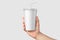 Paper soda cup in a hand with straw mockup template,  on light grey background.