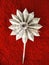 Paper sunflower on a red background.