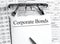 Paper with text Corporate Bonds a financial tables with glasses